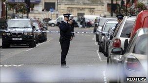 A police officer outside a depot of Westminster cleaning contractors Veolia