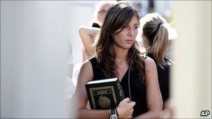 A woman holding a copy of the Koran after meeting Libyan leader Muammar Gaddafi in Rome, 29 August 2010