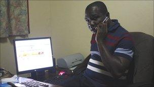 Jacques Kouakou - head of cocoa cooperative Fiedifoue, based in the town of Daloa - checks world prices on his computer