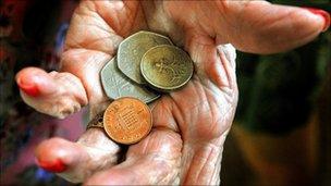 Elderly lady holding coins