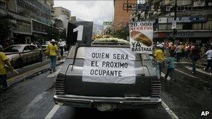 A hearse with a poster that reads in Spanish "Who will be the next occupant" and "20,000 deaths is enough" during an opposition protest against violence in Caracas, in August