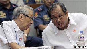 Archbishop Oscar Cruz (left) talks to Rico Puno during a senate inquiry on illegal gambling in Manila on 21 September 2010