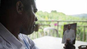 Alex Dole looks at a photo of his kidnapped son Thierry at his home on the French Caribbean island of Martinique, 19 September