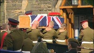 Kingsman Deady's coffin being carried into church