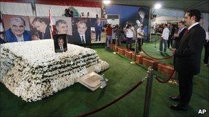 Lebanese Prime Minister Saad Hariri, right, the son of slain former Lebanese Prime Minister Rafik Hariri, prays at his father grave in downtown Beirut, 9 November 2009