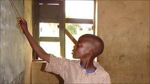 Nigerian boy writing on the blackboard