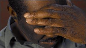 Man with hand over his face