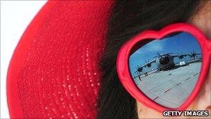 Reflection of a military plane in sunglasses