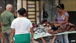 A woman sells shoes in Havana