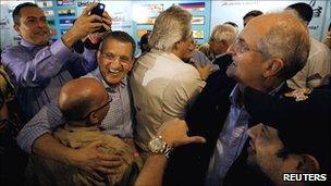 Members of the Venezuelan opposition group the Table for Democratic Unity (MUD) celebrate results of parliamentary elections in Caracas on Monday