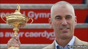 USA team captain Corey Pavin holding the Ryder Cup trophy arrives with the USA team at Cardiff Airport