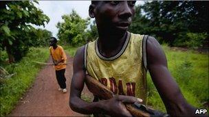 Members of the self-defence group known as the Arrow Boys patrol in a village between the southwestern towns of Yambio and Tambura in southern Sudan on May 22, 2010, against attacks from the Ugandan Lord's Resistance Army (LRA) rebel group