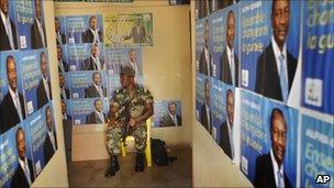 Guinean soldier surrounded by election posters