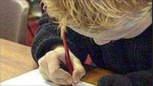 Boy writing in classroom