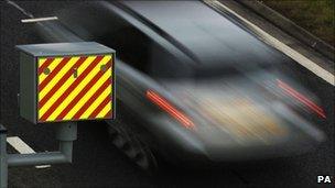 A car driving past a speed camera