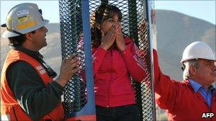 Carolina Lobos, daughter of Franklin Lobos, one of the 33 miners trapped in San Jose mine, checks the capsule