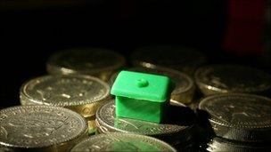 Monopoly piece on cash