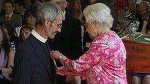 Reverend Andrew Jolly receiving MBE from the Queen