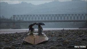 Upturned boat by river