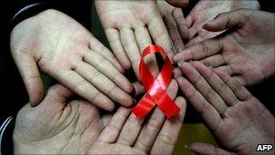 Chinese students show a handmade red AIDS ribbon. Hanshan, Anhui province, China