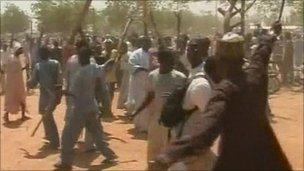 Protesters holding sticks