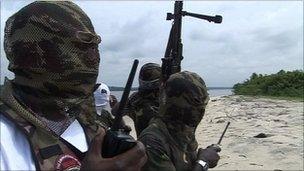 Hooded men on a beach