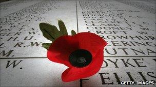 A remembrance poppy on a memorial displaying the names of some of the missing from WWI and WWII in Ypres, Belgium, on 5 November 2008