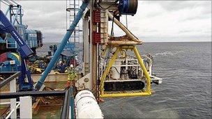 ROV being lowered from barge