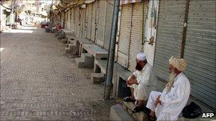 Tribesmen sit along a closed market in Miranshah, the capital of North Waziristan