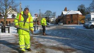 Council workers shovelling grit, gritting roads in Leicestershire, England, Feb 2009