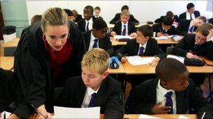 LONDON - SEPTEMBER 4: A teacher helps a student during a lesson at The Cardinal Vaughan Memorial School on September 4, 2003 in London.