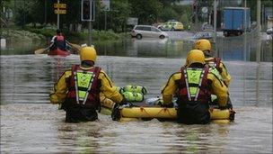 Fire rescue team with a boat, dingy in a flooded road, street Tewkesbury, July 2007