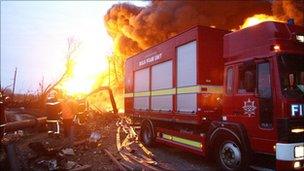 The fire brigade attend at the scene, after an explosion and fire at the Buncefield oil depot near Hemel Hempstead . 2005.