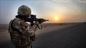 British soldier, airman on dawn patrol at sunrise in Basra, Iraq, Feb 2009.