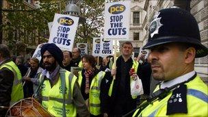 LONDON, UNITED KINGDOM: British civil service unions protesters are watched by police as the march through London 05 November 2004. Civil servants staged their biggest strike in more than a decade in a bitter row over jobs.