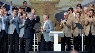 Wales' First Minister Carwyn Jones hands the Ryder Cup trophy to Colin Montgomerie