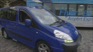 Blue taxi at station