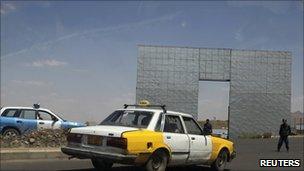 Policemen stop cars near the British embassy in Sanaa, Yemen, after the rocket attack