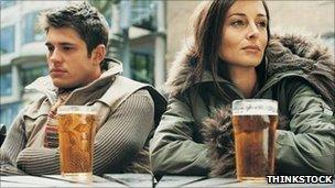 Two people drinking pints