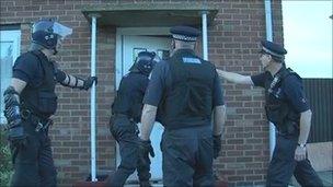 Police officers raid house