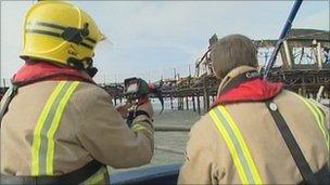 Firefighters take pictures of Hastings Pier