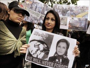 People of Iranian descent hold images of Neda Agha-Soltan at a protest outside the Iranian embassy in Zurich, Switzerland (24 June 2009)