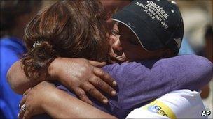 Maria Segovia, sister of Dario Segovia, one of the 33 miners trapped at the San Jose mine, is comforted outside the mine, near Copiapo, Chile, October 11, 2010