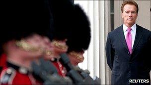 Arnold Schwarzenegger watches the changing of the guard during a visit to Wellington Barracks.