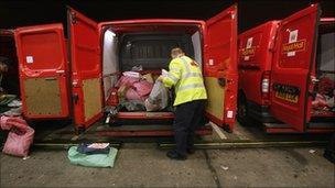 Postman unloading a van at a sorting office in Bristol