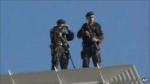 Turkish soldiers on security duty on a rooftop near the courthouse in Diyarbakir