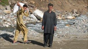 Businessman Farmanullah stands at the site where his furniture factory once stood