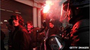 Students face riot policemen as clashes appeared between students and police during a demonstration against the pension reform on October 14 2010 in Dijon, eastern France.