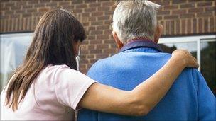 Woman helping an elderly man