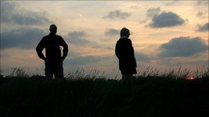 Silhouetted figures at sunset